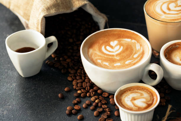 istock Espresso and coffee cups with coffee beans in background 1254749025
