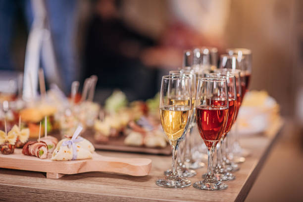 Wine and canapes appetizers on table Beautifully arranged wine in wine glasses and different species canapes appetizers on buffet table. canape stock pictures, royalty-free photos & images
