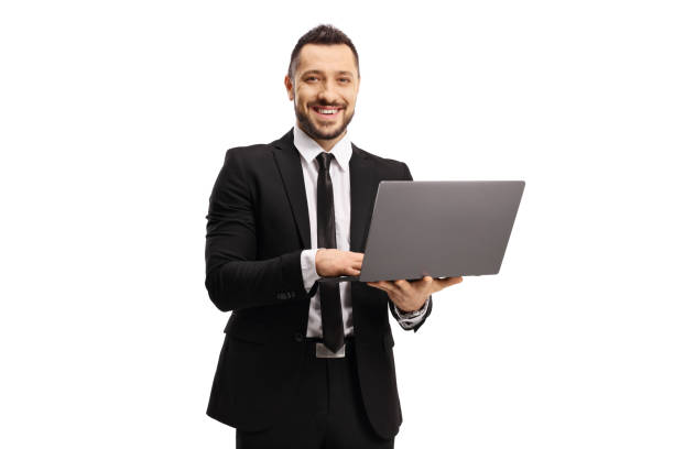 istock Businessman working on a laptop computer and smiling at the camera 1254751480