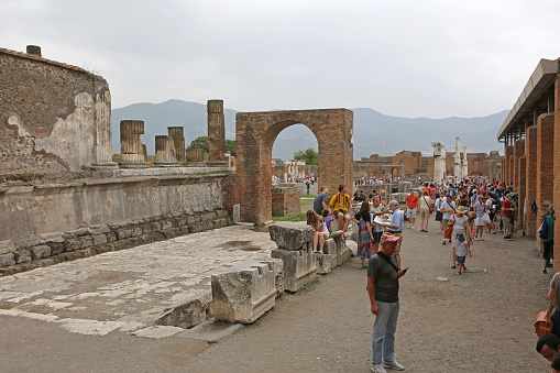 Pompei, Italy - June 25, 2014: Crowd of Tourists at Ancient Roman Temple Ruins World Heritage Site Near Naples, Italy.