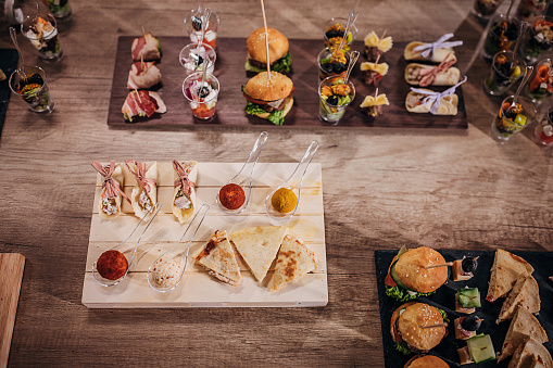 Different species of canapes appetizers on buffet table, ready to eat.