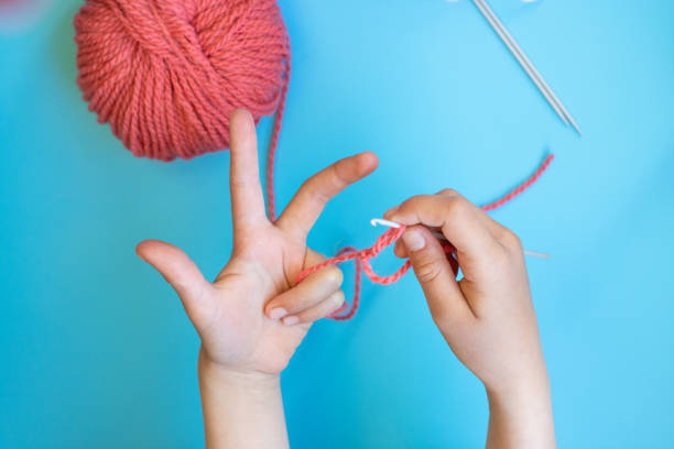 Colorful big cotton thread ball in hands.