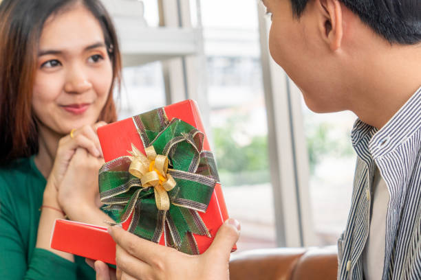 istock Happy couple giving gift present to celebrate 1254755893