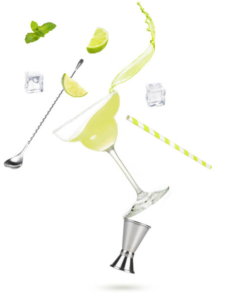 concept of making refreshing cocktail using barman's tools cocktail glass, splash, lime, ice cubes and bartender accessories flying on white background, concept of preparing margarita or daiquiri cocktail tequila drink photos stock pictures, royalty-free photos & images