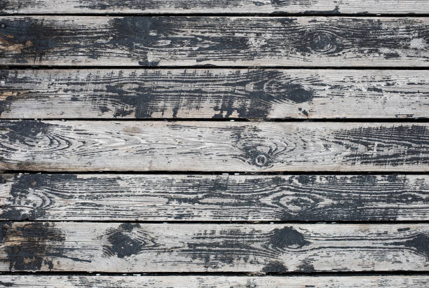 istock Weathered black and white wooden background texture. 1254756413