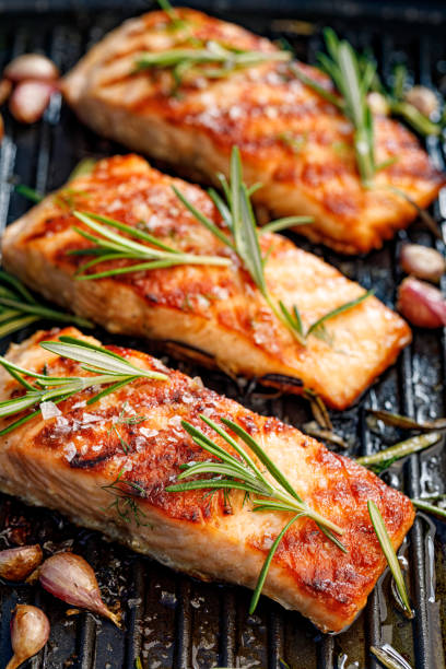 Grilled salmon fillets sprinkled with fresh rosemary and lemon juice