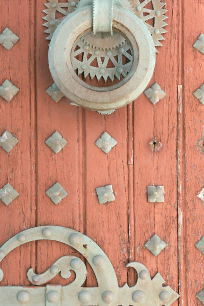 istock Monastery old wood door with a metal pattern. 1254758406