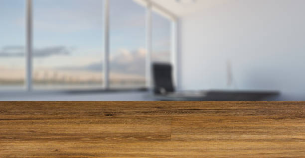 istock blurred interior on a wooden table background. Head office with a large window. modern furniture.. 3D rendering 1254760133