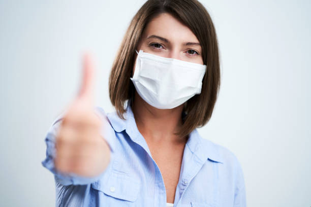 istock Attractive woman wearing protective mask isolated over white background 1254760912
