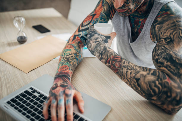 istock One young tattooed man working from home 1254761160