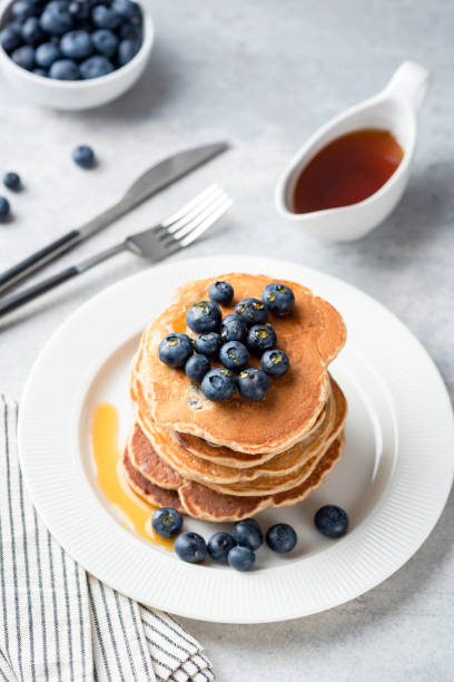 istock Pancakes with blueberries and maple syrup on plate 1254761424