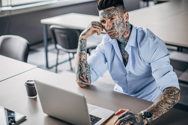 istock One tattooed businessman working in office 1254762146