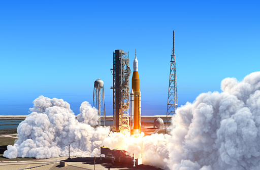 Melbourne, Florida - January 31, 2022: Spectators on the beach watch as a SpaceX Falcon 9 rocket launches at sunset from Cape Canaveral Space Force Station with the CSG-2 mission.