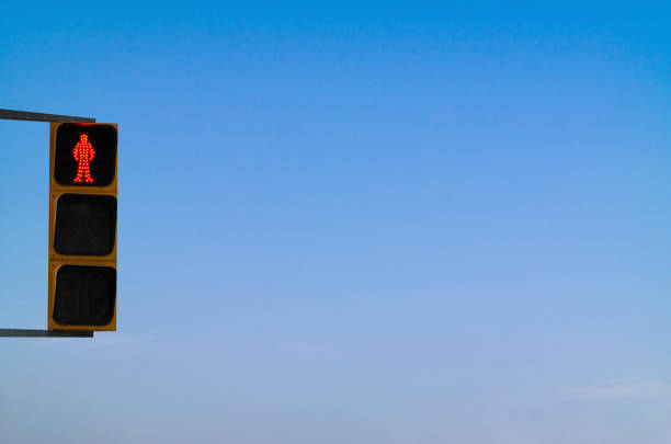 I filmed a red traffic light in the background of a cloudless blue sky.