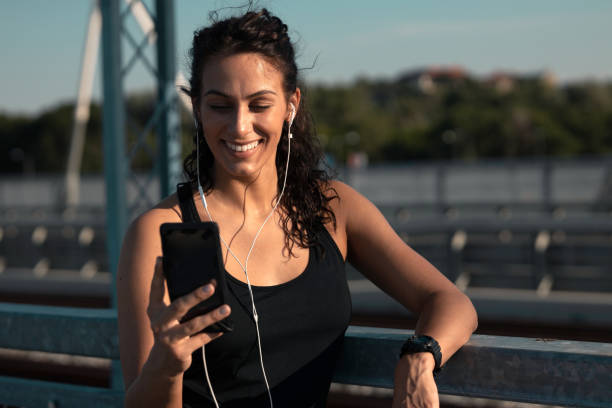 istock Fitness woman using smart phone 1254763676