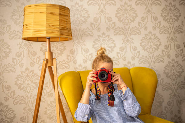 Woman sitting in the vintage living room and having a photo