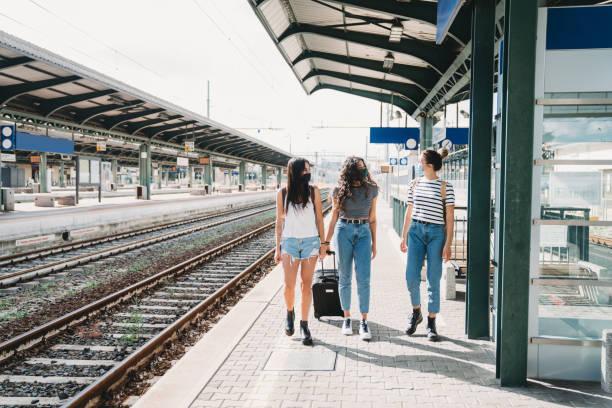 istock Friends traveling together wearing facemasks 1254765911