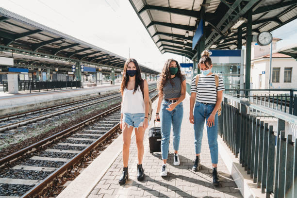 istock Friends traveling together wearing facemasks 1254765913