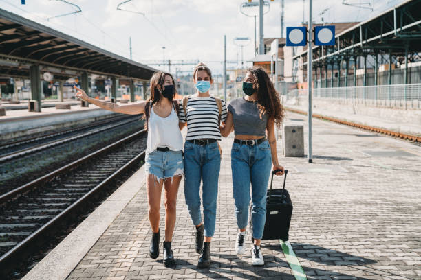 istock Friends traveling together wearing facemasks 1254765928