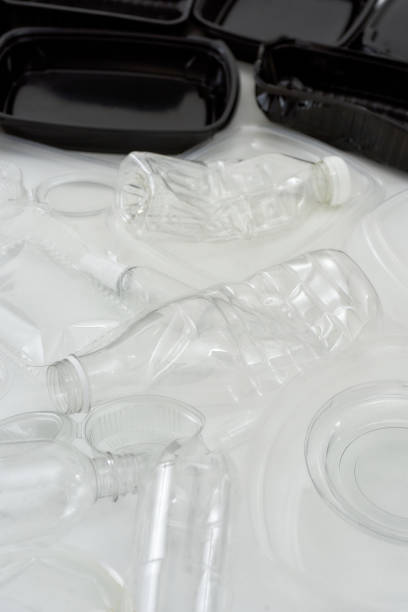 istock Close up shot of empty black and white plastic containers over white background 1254766497