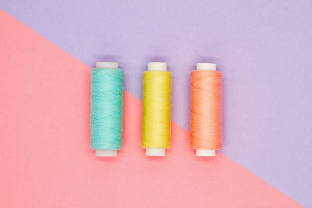 istock Top view of multi-colored sewing reels on a colored background. Hobby concept 1254766863
