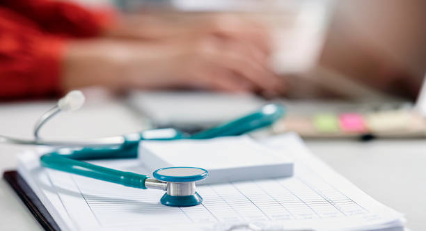 istock Closeup green stethoscope on doctor table. 1254768137