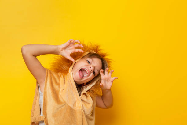 istock Child in lion costume roaring 1254772843