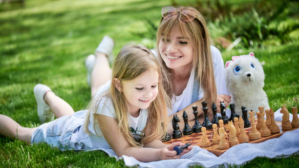 istock Mother and daughter playing chess 1254772854