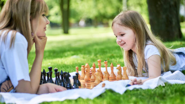 istock Mother and daughter playing chess 1254772918