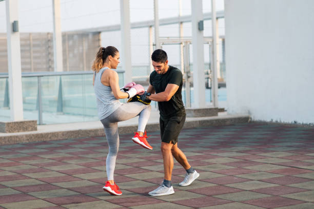 Fit couple sparring martial arts and going through kickboxing routines