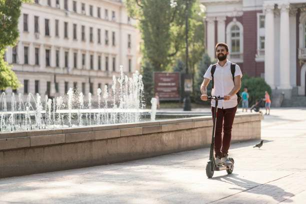 istock Man riding e-scooter in the city 1254776031