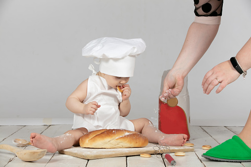 Preparing for a photo shoot on your first birthday. A child in a cook suit is preparing for a photo shoot
