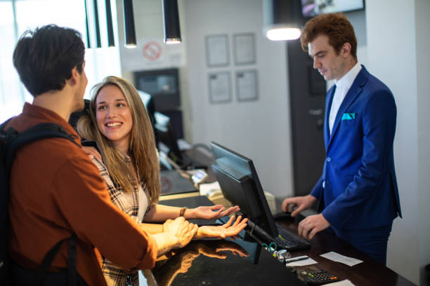 istock Young couple checking in at luxury hotel 1254776718
