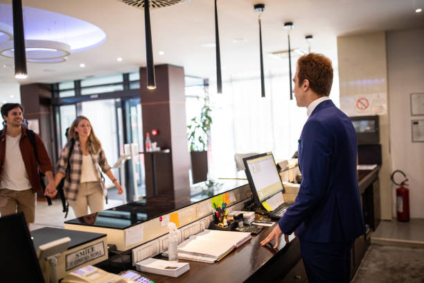 istock Young couple approaching reception at luxury hotel 1254776739