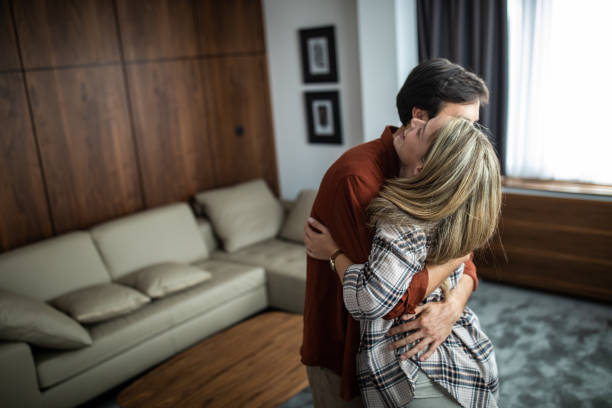 istock Young couple embracing at hotel suite 1254777581