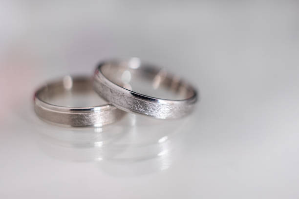 istock Close-up of two wedding rings with a reflexion. 1254778094