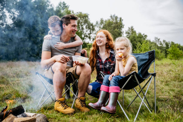 istock Father enjoying camping trip with three children 1254778101