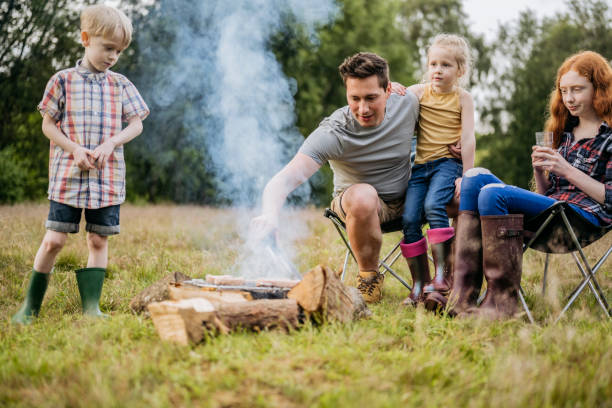 istock Caucasian single father cooking over campfire with children 1254778103