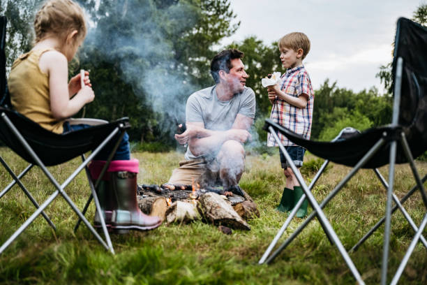 istock Single father enjoying cookout with children on camping trip 1254778128