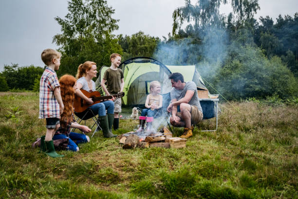 istock Family with four children enjoying singing around campfire 1254778140