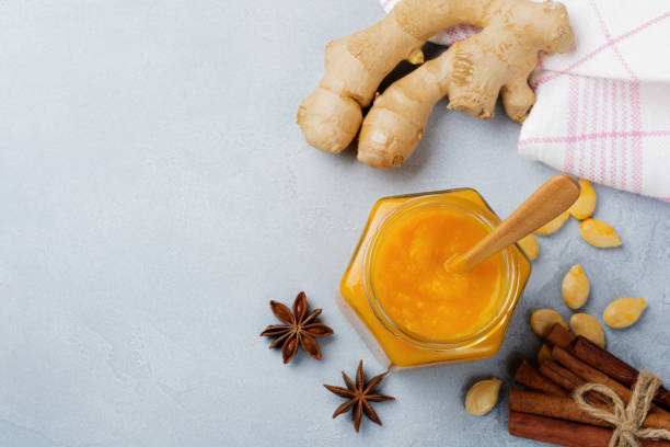 istock Spicy pumpkin puree with cinnamon, anise and ginger in a sealed can on a light stone or concrete background. Selective focus. Top view. 1254779268