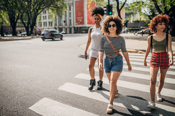 istock Three young women walking down the street 1254780459