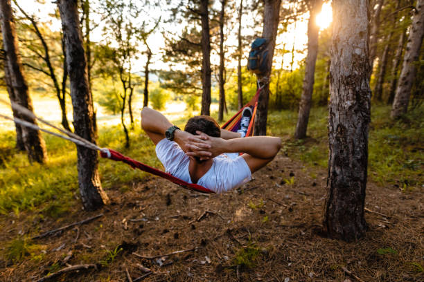 istock Man relaxing and meditating in hammock while enjoying alone time in nature 1254780469