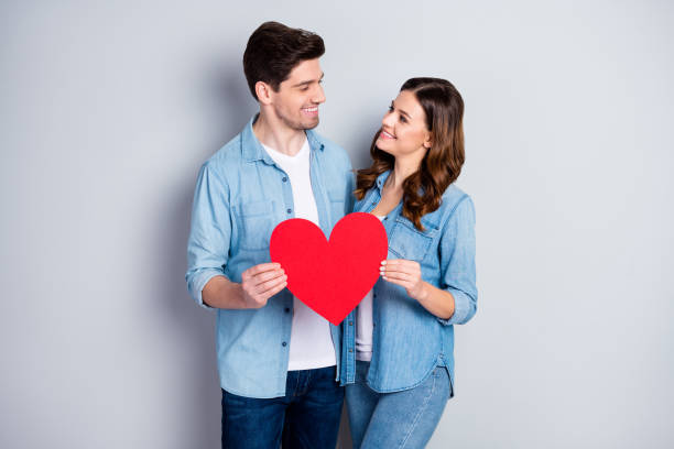 istock Photo two people charming lady handsome guy demonstrating per paper heart figure postcard symbolizing love wear casual denim shirts outfit isolated grey color background 1254782223