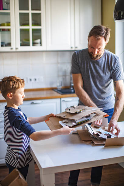 istock Father and son sorting waste at home 1254782258