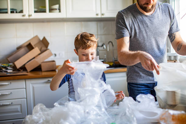 istock Father and son sorting waste at home 1254782304