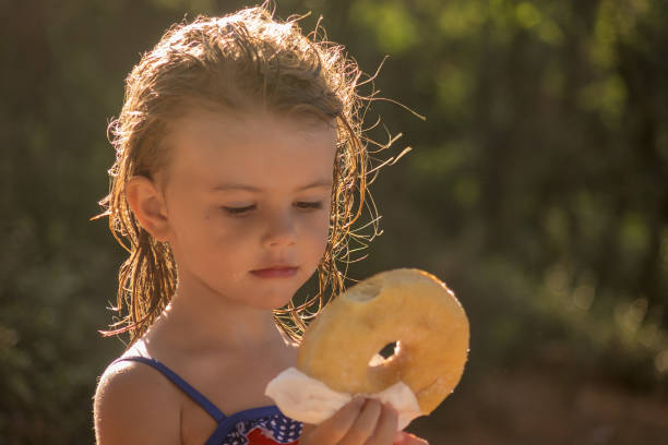 little girl  eating a donut