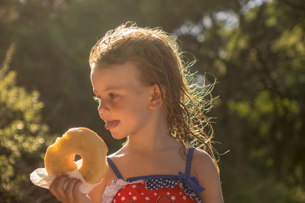 little girl  eating a donut