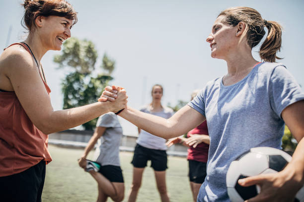 istock Women handshake outdoors on a soccer field 1254785808