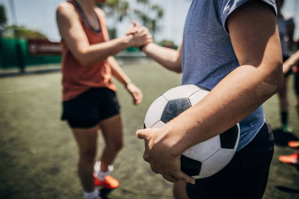istock Women handshake on a soccer field 1254785863